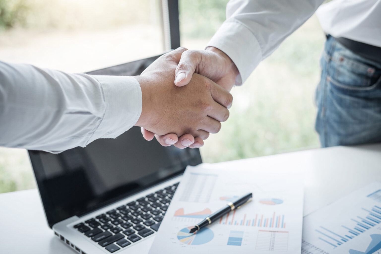 Finishing up a meeting, Business handshake after discussing good Finishing up a meeting, Business handshake after discussing good deal of Trading to sign agreement and become a business partner, contract for both companies, Successful businessman handshake.
