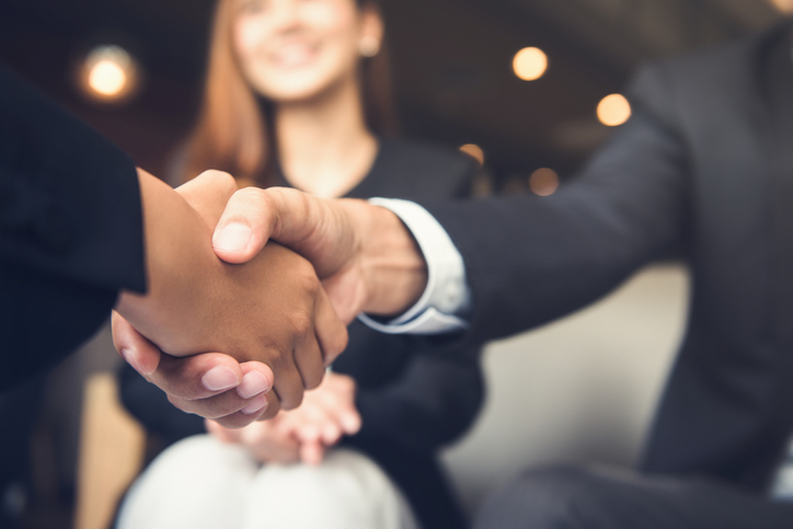Businessmen shaking hands after meeting in a cafe Businessmen making handshake with his partner in cafe - business etiquette, congratulation, merger and acquisition concepts