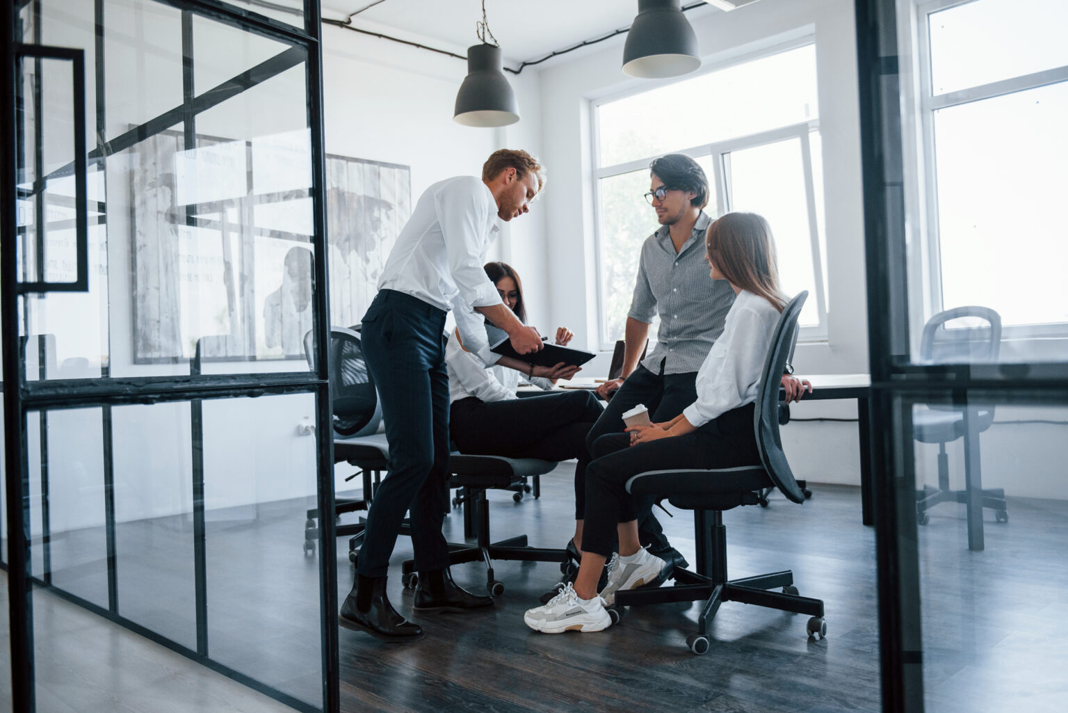 Active conversation. Young business people in formal clothes working in the office Active conversation. Young business people in formal clothes working in the office.