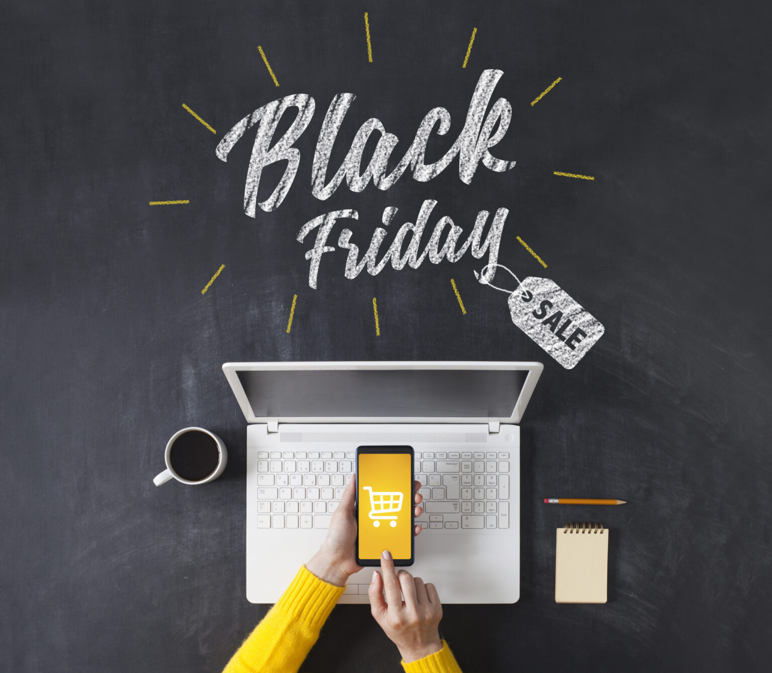 Black friday advertisement on blackboard. Woman shopping with smart phone app. Online e-commerce shopping concept.