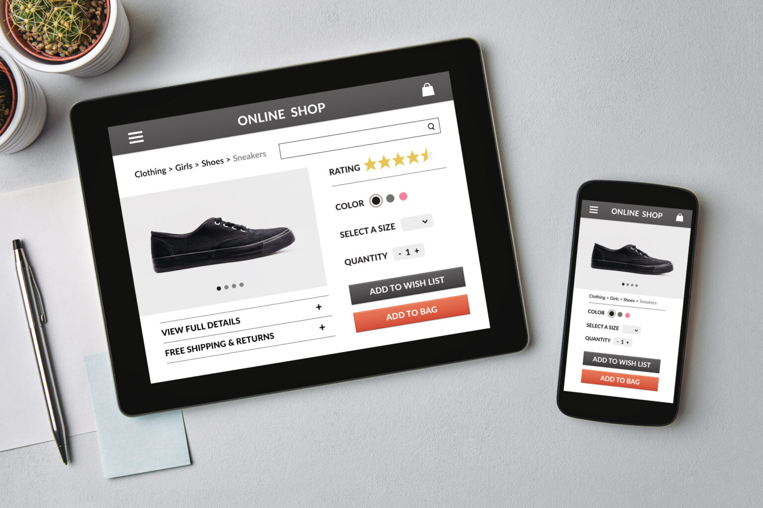 Online shop concept on tablet and smartphone screen Online shop concept on tablet and smartphone screen over gray table. All screen content is designed by me. Flat lay