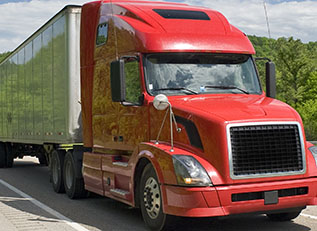 Red Semi Truck On Interstate In Springtime Abundant spring rains and a polarizing filter combine to produce a beautiful background for this truck’s trip down the freeway.