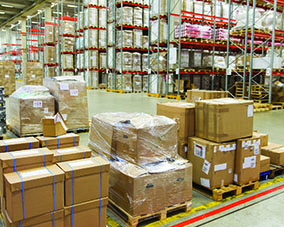 logistic, storage, shipment, industry and manufacturing concept - cargo boxes storing at warehouse shelves