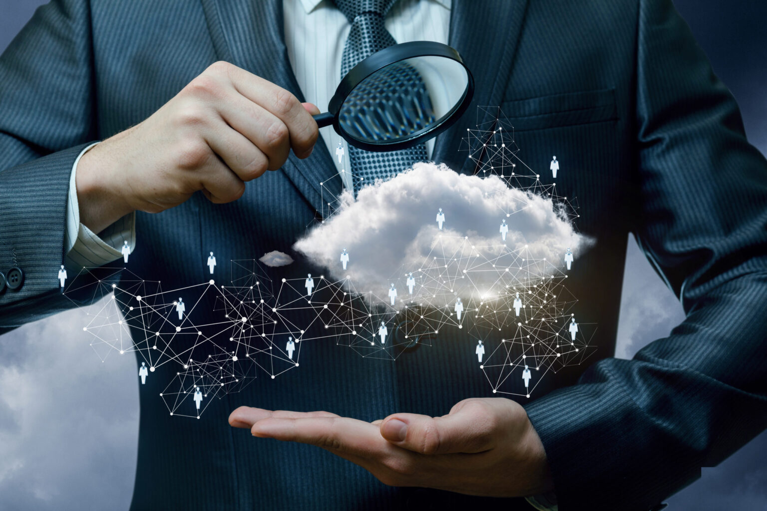 A businessman looking at the data cloud and human resources structure through the magnifier. A closeup of a businessman looking at the data and information cloud and human resources structure through the magnifier. The human resources and information concept.