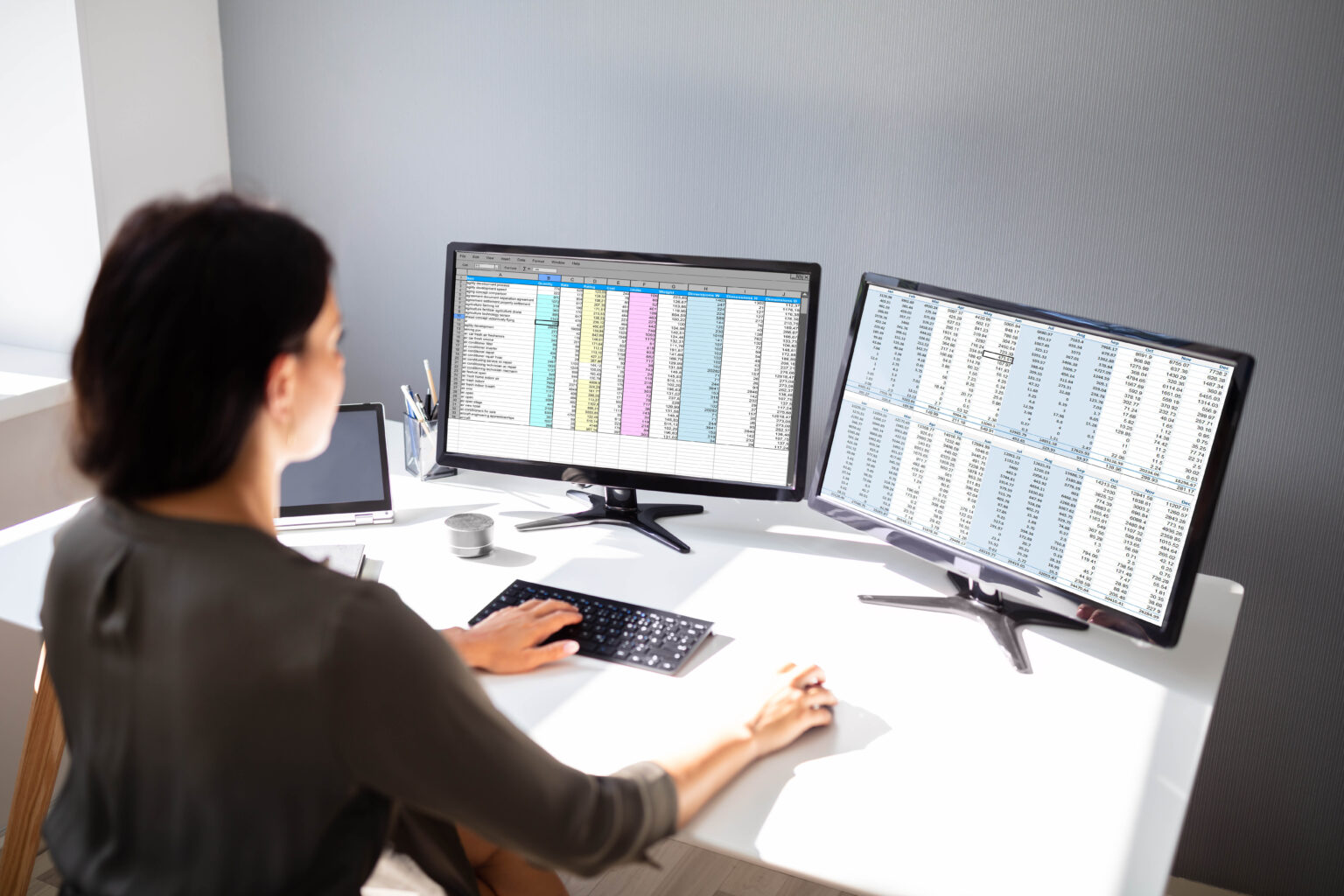 Businesswoman Working On Computer Side View Of Businesswoman's Hand Analyzing Data On Computer Over Desk
