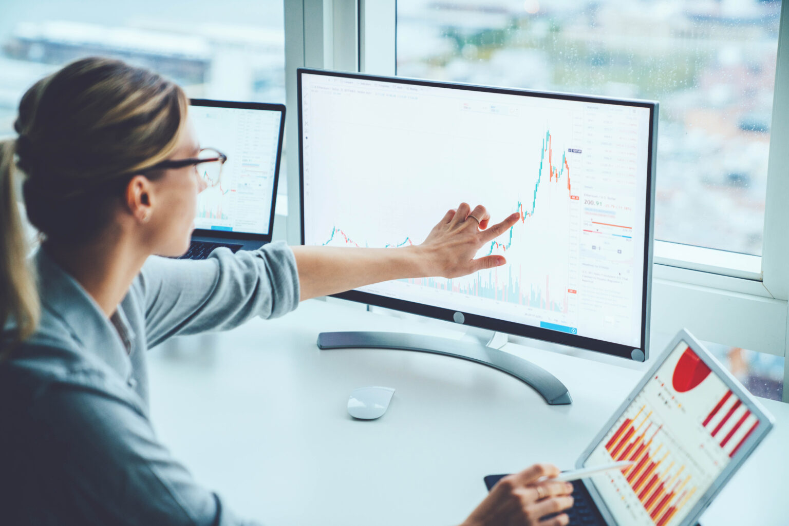 Business woman study financial market to calculate possible risks and profits.Female economist accounting money with statistics graphs pointing on screen of computer at desktop. Quotations on exchange Business woman study financial market to calculate possible risks and profits.Female economist accounting money with statistics graphs pointing on screen of computer at desktop. Quotations on exchange
