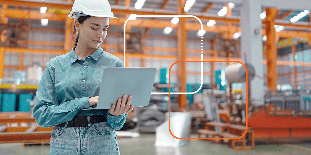 person looking at a laptop in a warehouse