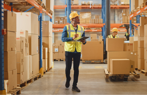 a worker in a warehouse holding a clipboard a worker in a warehouse holding a clipboard