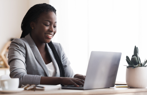 corporate woman smiling at laptop